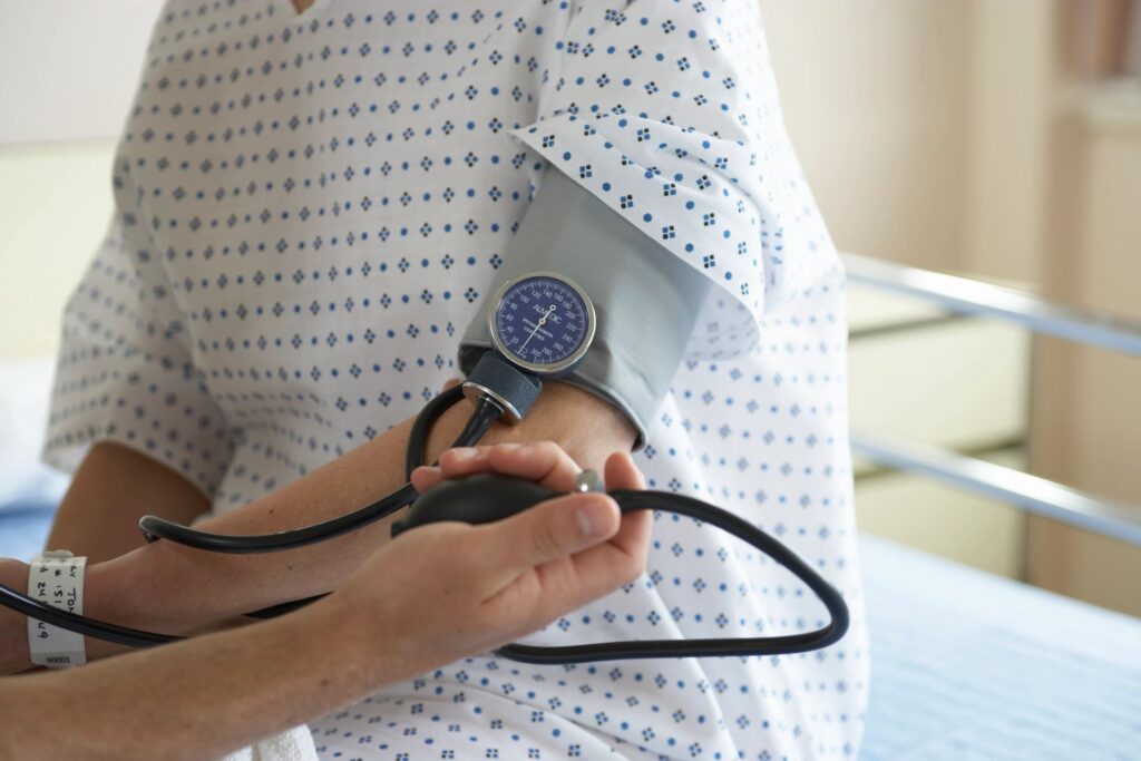 Healthcare worker measuring patient's blood pressure